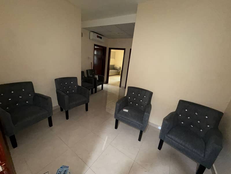 Furnished 2-bedroom apartment and hall in Liwara 1, second row from Ajman Corniche, big balcony, split AC, AED 30,000 yearly in 4 payments, AED 5,000