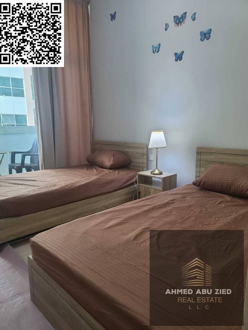 2BR furnished apartment for yearly rent in Ajman One Towers, prime location above restaurants and near the Corniche, AED 54,000 in 4 payments