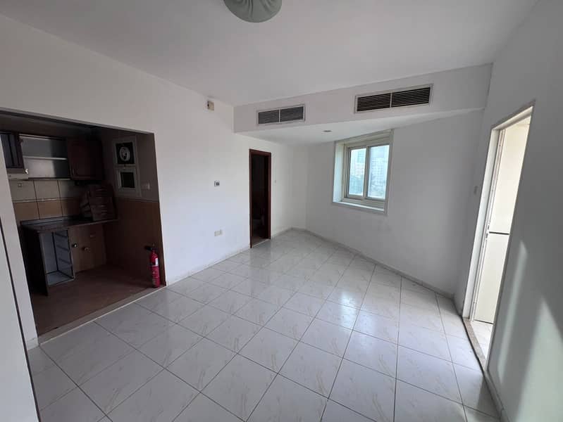 A studio apartment is available for annual rent in Al Rashidiya 3, located on Old Traffic Street in a prime and vibrant location close to all daily am
