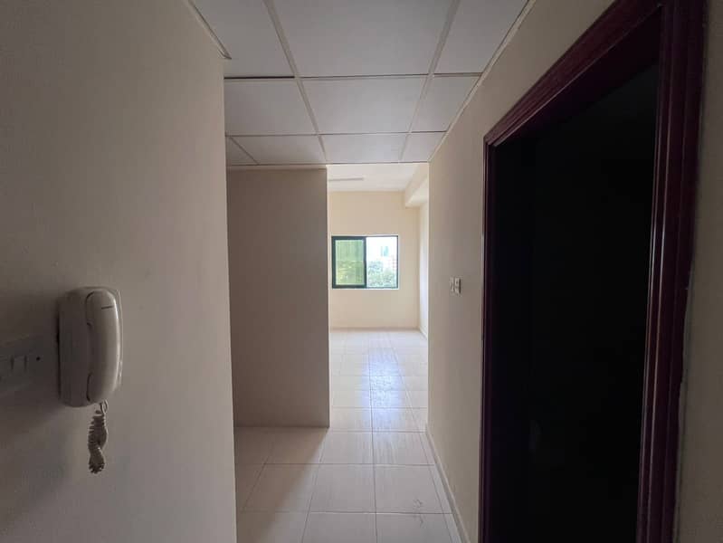 Upscale studio apartment with separate kitchen in Ajman, central air conditioning, prime location, family-only accommodation.