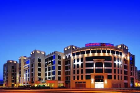 استوديو  للايجار في الممزر، دبي - Mövenpick Hotel Apartments Al Mamzar - Exterior night. jpg