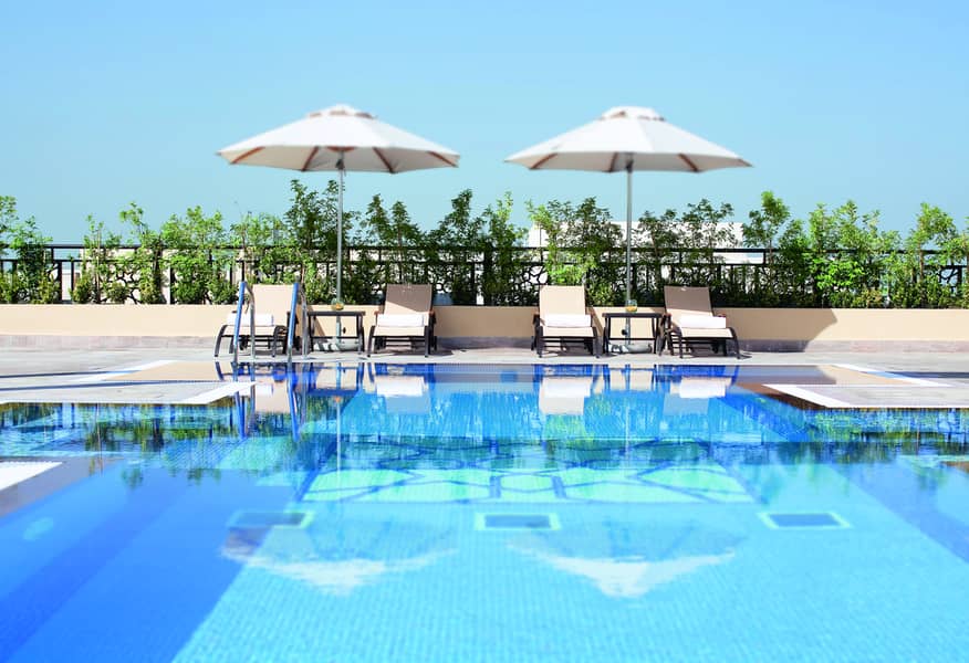 3 Swimming pool - Mövenpick Hotel Apartments Al Mamzar. jpg