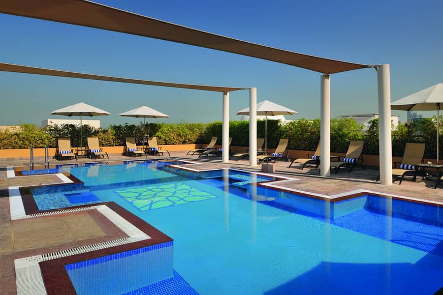 4 Swimming pool (Overview) - Mövenpick Hotel Apartments Al Mamzar. jpg