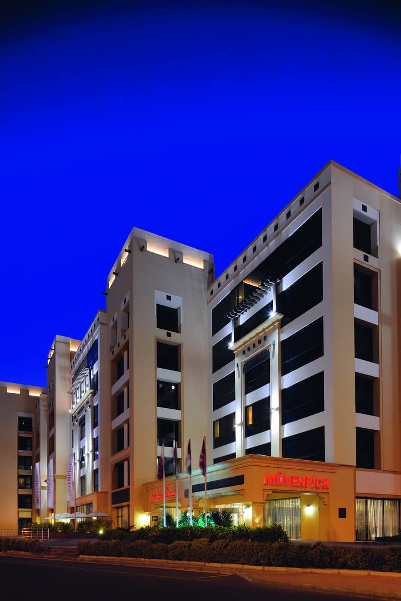 7 Mövenpick Hotel Apartments Al Mamzar - Exterior night portrait. jpg