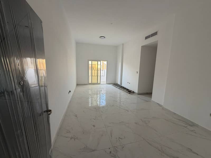 Two-bedroom apartment with a living room for annual rent in Al Muwaihat 3, Ajman. Features include a master bedroom, two bathrooms, a balcony