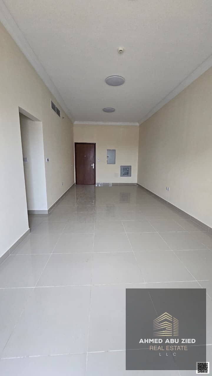 2BR apartment in Al Jurf, Ajman, master room with wardrobes, spacious hall, balcony, central AC, modern finish, free maintenance, near services