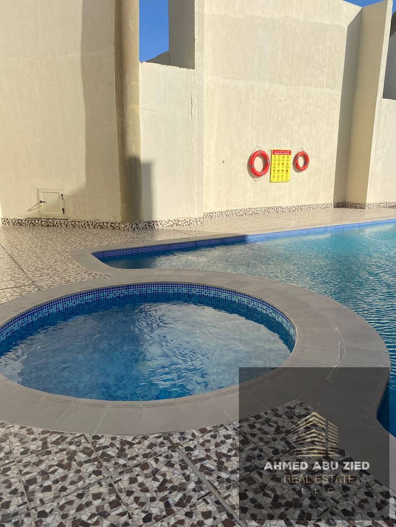 2-bedroom apartment with living room in Emirates City, 2 bathrooms, master room, built-in wardrobes, free gym & pool, prime location, 4-installment pa