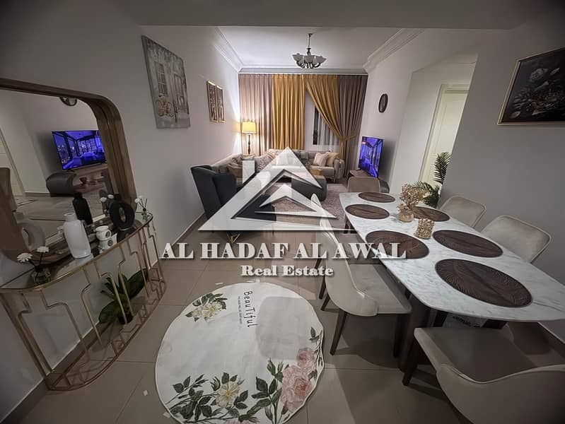 Two bedrooms and a living room for monthly rent, second tenant, with parking, near the Dubai entrance