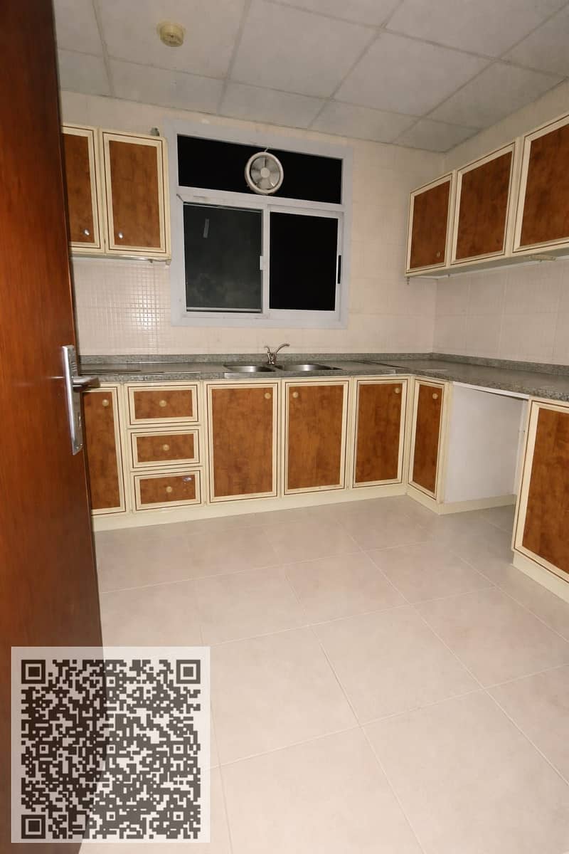 Two-bedroom apartment with a living room for annual rent in Al Rashidiya 1, Ajman, near the port road, with an open view.