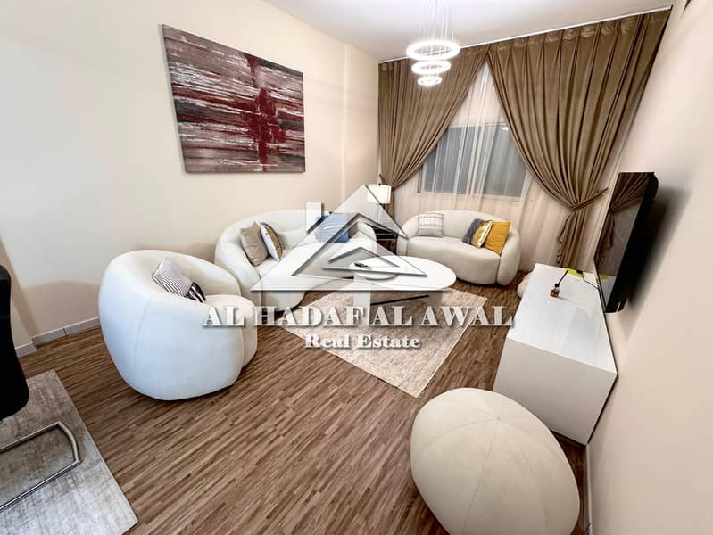 Two bedrooms and a living room in Al Qasba, with two bathrooms and a balcony. Rent includes all bills: 6000, security deposit 1000.