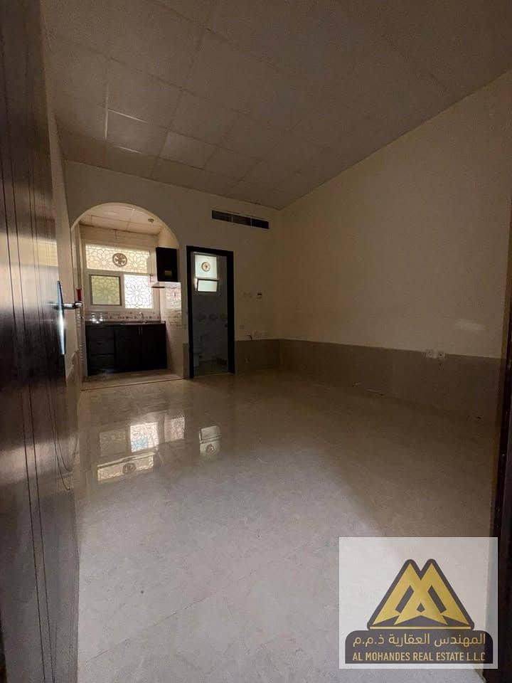 Studio for rent in Al Jurf 2, Ajman, ground floor with semi-separate kitchen, spacious, central AC, prime location near services, AED 20,000 yearly in