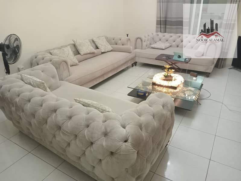 Sharjah, Al Taawun area: One bedroom, living room, kitchen, two bathrooms, and a balcony on the main street. Price: 3799 AED including internet.