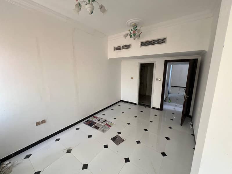 Al Rawda 3: Huge 2BHK & Balcony. 45k (4 checks). Central AC & Free Maintenance. Near Sheikh Ammar St. Deposit 5000 AED by undated check. Prime locatio