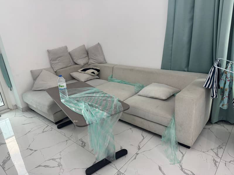 Two bedrooms and a living room in Al Waha Towers, prime location close to all services, easy access to Dubai and Sharjah roads.