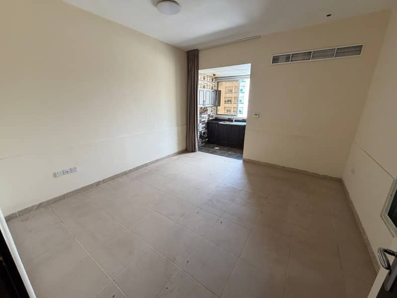 Studio apartment for annual rent in Al Rashidiya, Ajman, opposite the Ladies' Park. New building, full maintenance included by the owner, central air