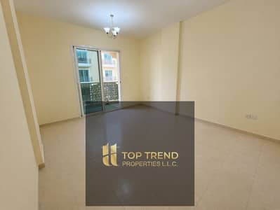 Studio for Rent in International City, Dubai - Empty modern apartment with balcony view. png