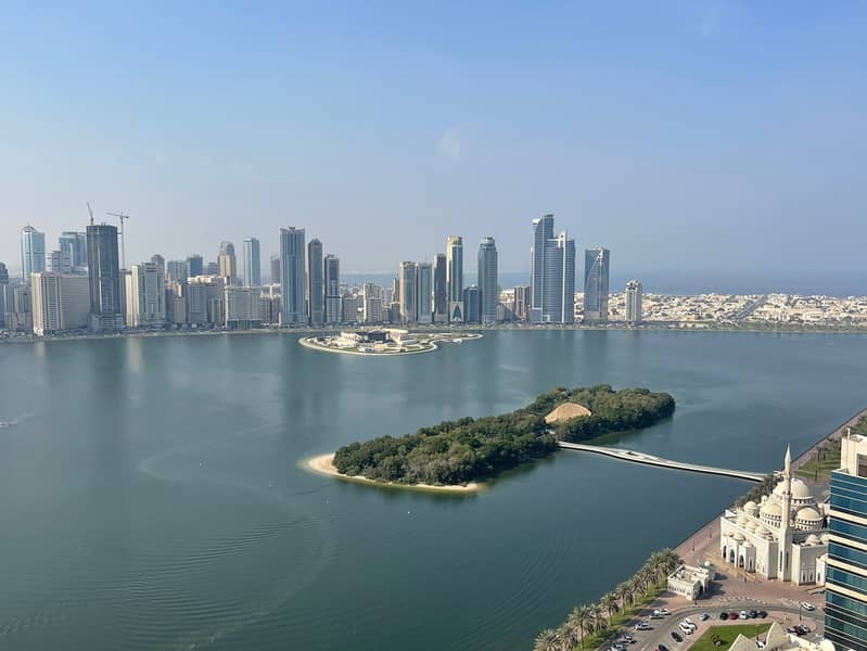 Sea view | free AC, parking, gym & pool | 2BR hall, 2 balconies, laundry, 2 baths | prime location on Khalid Lagoon