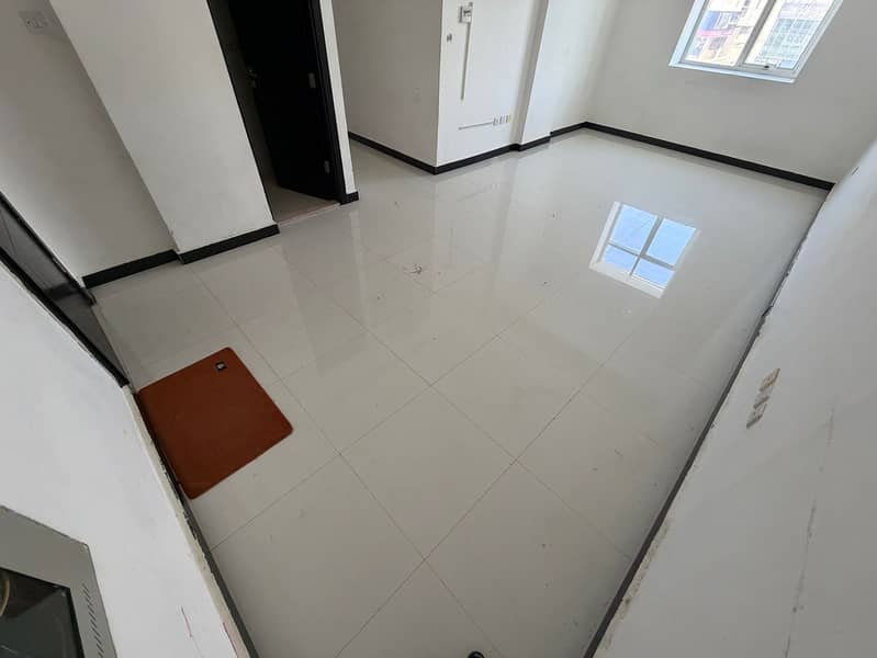 Two bedrooms and a living room for annual rent in Al Rawda, Ajman. Two bathrooms, central air conditioning, and maintenance is included by the owner.