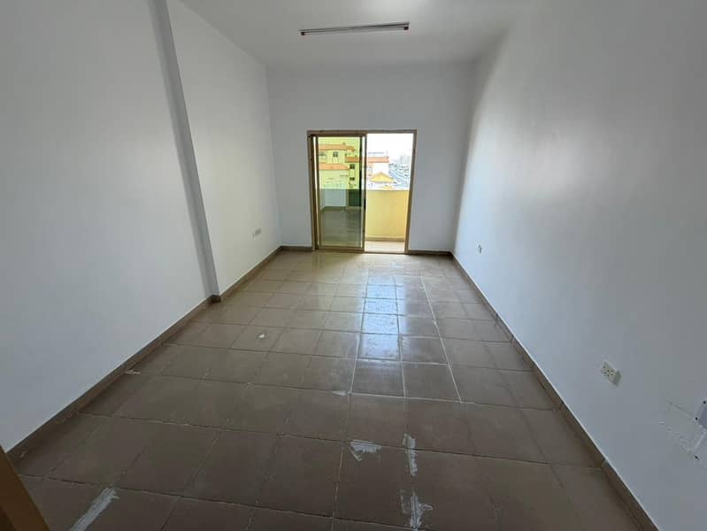 Two-bedroom apartment with a separate living room, central air conditioning, balcony, and two bathrooms in Al Hamidiya. Prime location near the court