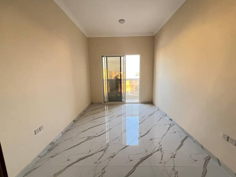 One-bedroom apartment for annual rent, second occupant, with a separate living room, central air conditioning, and two bathrooms in Al Muwaihat.