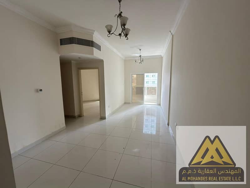 The apartment features two bedrooms, a large living room, two bathrooms, and a balcony that provides natural light and ventilation. The spacious layo
