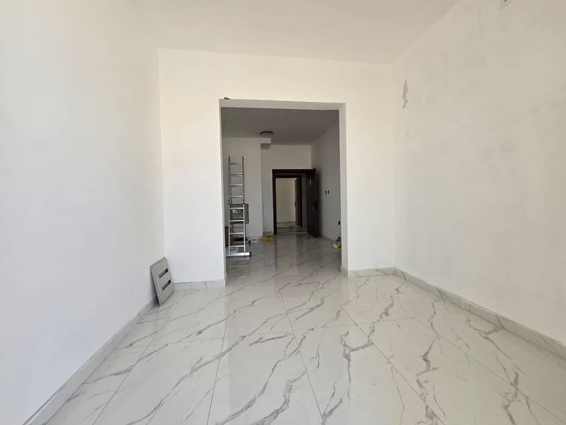 Al Muwaihat, near the academy on the Mohammed Bin Zayed exit, studio apartment for annual rent. First occupancy. Central air conditioning. Maintenance