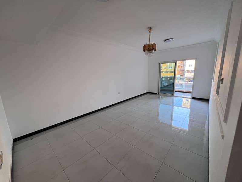 Al Muwaihat 3, on the main road in Ajman, a two-bedroom apartment with a living room for annual rent. It features two bathrooms, a balcony,