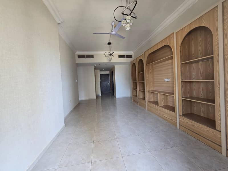Ajman, UAE - Two-bedroom apartment for annual rent. Features include: two master bedrooms, two bathrooms, balcony, built-in wardrobes, central air con