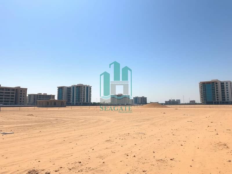 A_commercial_plot_for_sale_in_the_UAE_showcasing_a_wide_expanse_of_undeveloped_land_ideal_for_commercial_use_without_any_fences_or_cages. _The_scene_features_sandy_terrain_under_a_bright_blue_sky_with_modern_buildings. jpeg A_commercial_plot_for_sale_in_the_UAE_showcasing_a_wide_expanse_of_undeveloped_land_ideal_for_commercial_use_without_any_fences_or_cages. _The_scene_features_sandy_terrain_under_a_bright_blue_sky_with_modern_buildings. jpeg