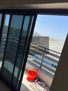 Available for annual rent in Umm Al Quwain, opposite Umm Al Quwain Mall, an apartment consisting of two master bedrooms, a living room, and three bath