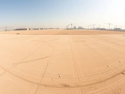 Mixed Use Land for Sale in Al Amerah, Ajman - A_panoramic_view_of_an_empty_industrial_lot_in_the_UAE_showcasing_a_vast_flat_landscape_marked_for_future_development. _The_ground_is_sandy_and_dry_with_faint_markings_indicating_plot_boundaries. _In_the_distance_there. jpeg