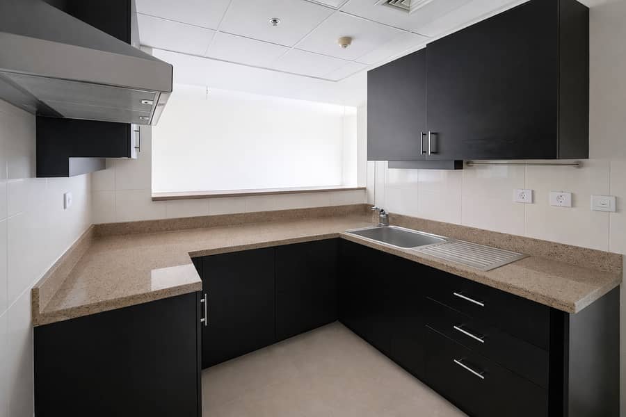 6 Modern L-shaped kitchen with natural light. png