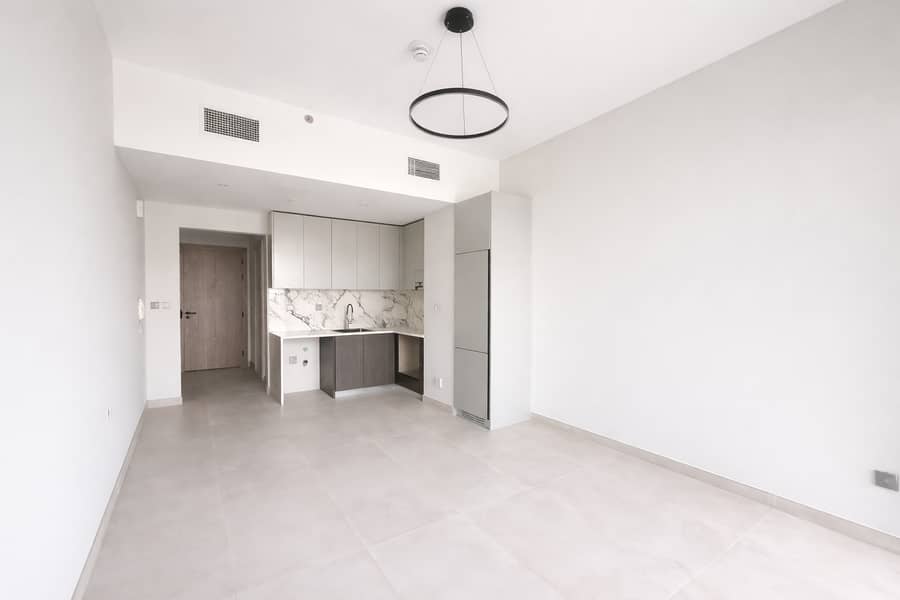 3 Modern studio with sleek kitchen design. png