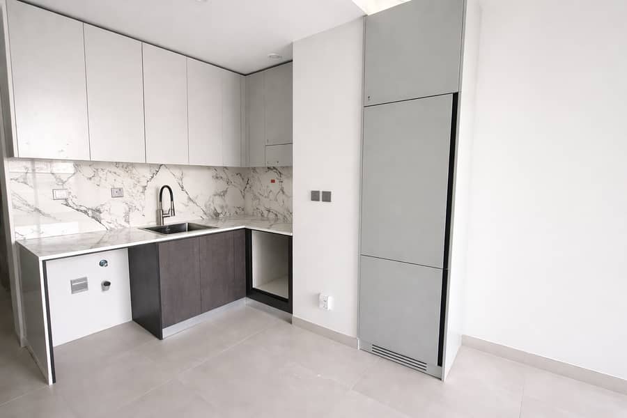 4 Sleek L-shaped kitchen with marble accents. png