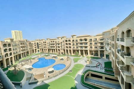 1 Bedroom Apartment for Sale in Jumeirah Village Circle (JVC), Dubai - Mediterranean courtyard with pools and terraces. png