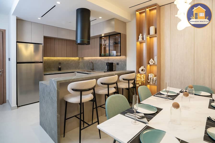 3 kitchen and living area in a 2 bedroom apartment for sale in Tulip Oasis 11 Majan. jpg