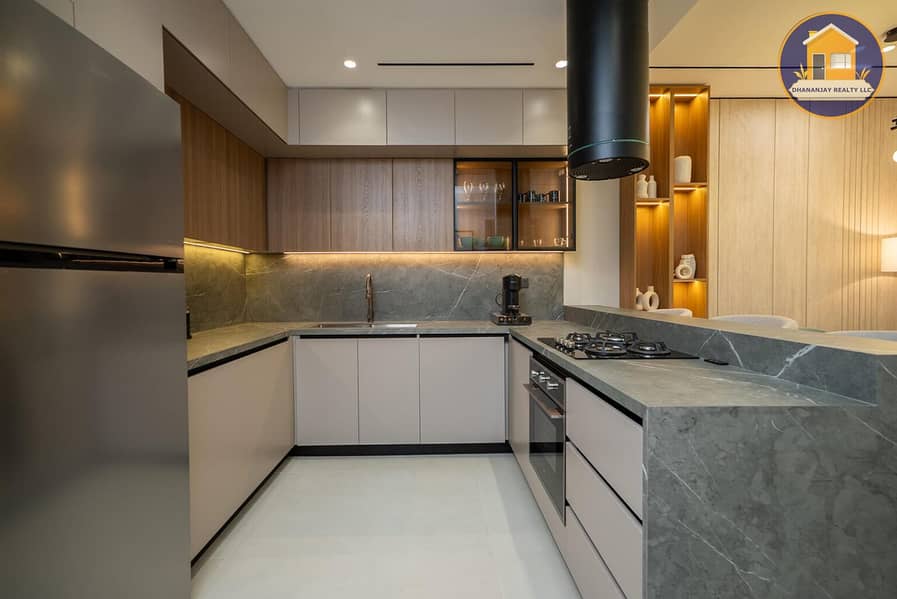 4 kitchen in a 2 bedroom apartment for sale in Tulip Oasis 11 Majan. jpg