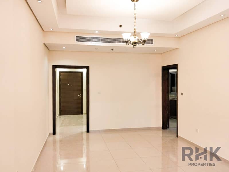 Entrance hallway and living space with chandelier in 1-bedroom Altia Residence apartment, Dubai Silicon Oasis Entrance hallway and living space with chandelier in 1-bedroom Altia Residence apartment, Dubai Silicon Oasis