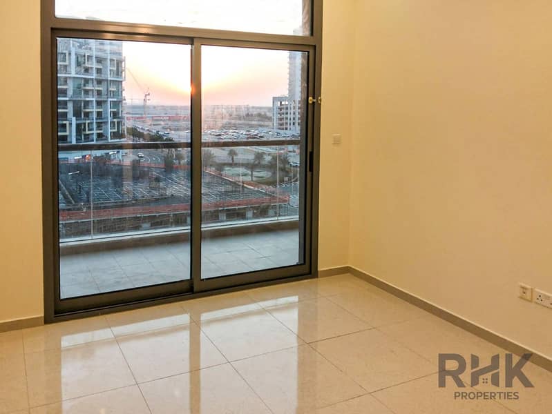 3 Bedroom with floor-to-ceiling balcony door and sunset view in Altia Residence Dubai Silicon Oasis