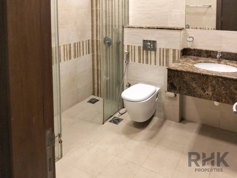 9 Modern bathroom with walk-in glass shower and marble vanity in Altia Residence, Dubai Silicon Oasis