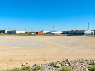 Industrial Land for Sale in Al Sajaa Industrial, Sharjah - An_empty_industrial_plot_of_land_characterized_by_a_spacious_area_covered_with_dirt_and_gravel_prepared_for_future_construction. _In_the_background_several_nearby_industrial_buildings_and_warehouses_are_visible_under - Copy. jpeg Industrial Land for Sale in Al Sajaa Industrial, Sharjah - An_empty_industrial_plot_of_land_characterized_by_a_spacious_area_covered_with_dirt_and_gravel_prepared_for_future_construction. _In_the_background_several_nearby_industrial_buildings_and_warehouses_are_visible_under - Copy. jpeg
