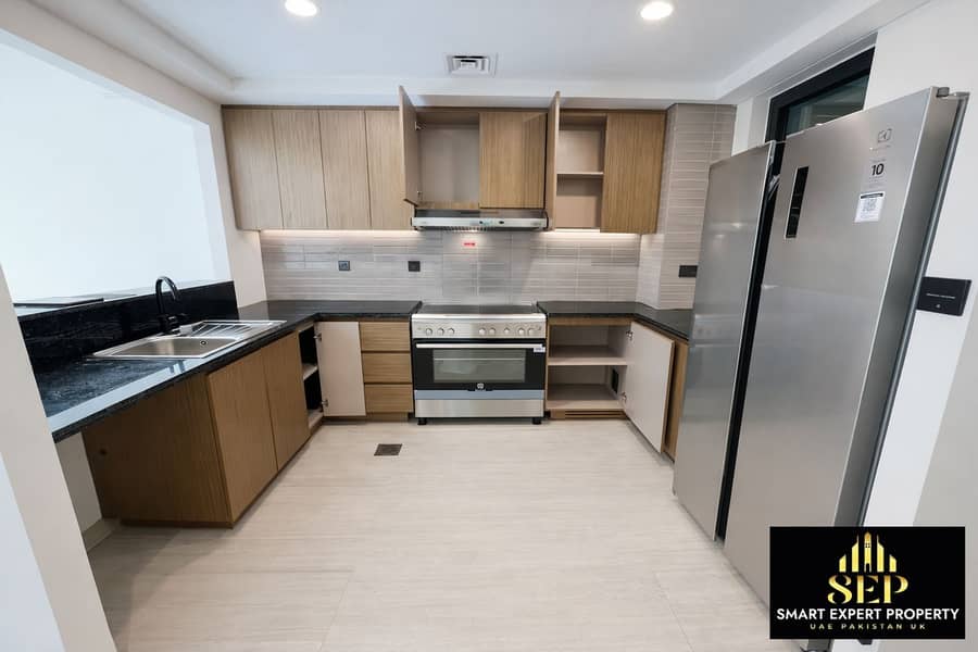7 Modern L-shaped kitchen with stainless steel accents (1). png