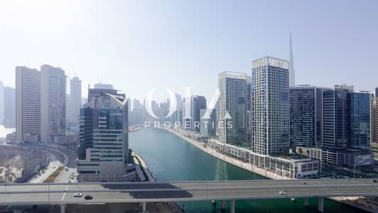 2 Bedroom Flat for Sale in Business Bay, Dubai - 01 Burj Khalifa and Canal View from Balcony. JPG