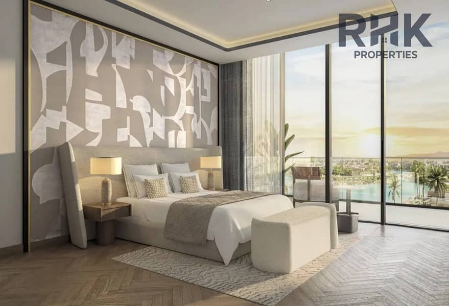 3 Azizi Venice bedroom with floor-to-ceiling windows and crystal lagoon view at sunset
