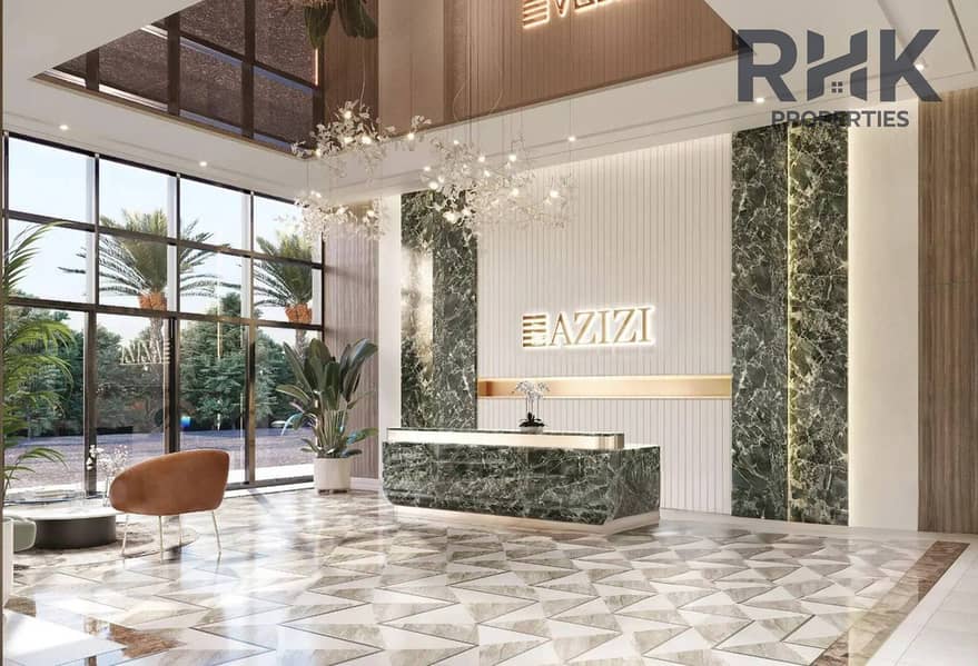 5 Azizi Venice lobby with green marble reception desk and floor-to-ceiling windows