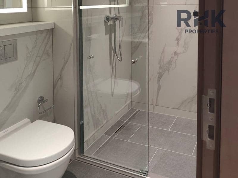 8 Marble-clad bathroom with walk-in glass shower in Crest Grande, Sobha Hartland