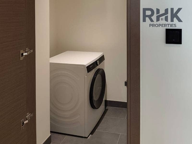 9 Separate laundry room with washing machine in Crest Grande apartment, Sobha Hartland