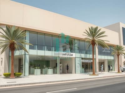 Shop in Affitto a Al Jurf, Ajman - Photorealistic_exterior_view_photo_of_a_modern_luxury_showroom_building_in_Al_Sajaa_Sharjah_UAE_wide_angle_street_level_shot. _Large_glass_storefront_windows_clean_contemporary_architecture_with_subtle_Arabic_inspired. jpeg
