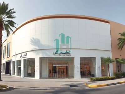 Shop in Affitto a Al Jurf, Ajman - Photorealistic_exterior_view_photo_of_a_modern_luxury_showroom_building_in_Al_Sajaa_Sharjah_UAE. _Same_wide_angle_street_level_composition_as_reference_clean_contemporary_facade_with_large_glass_storefront_windows_whi. jpeg