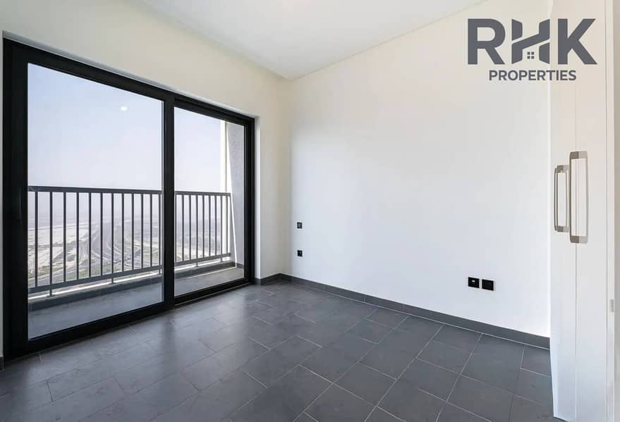 2 Empty bedroom with floor-to-ceiling windows and Ras Al Khor views, Sobha Hartland Dubaid | Burj Khalifa View | High Floor photo 2